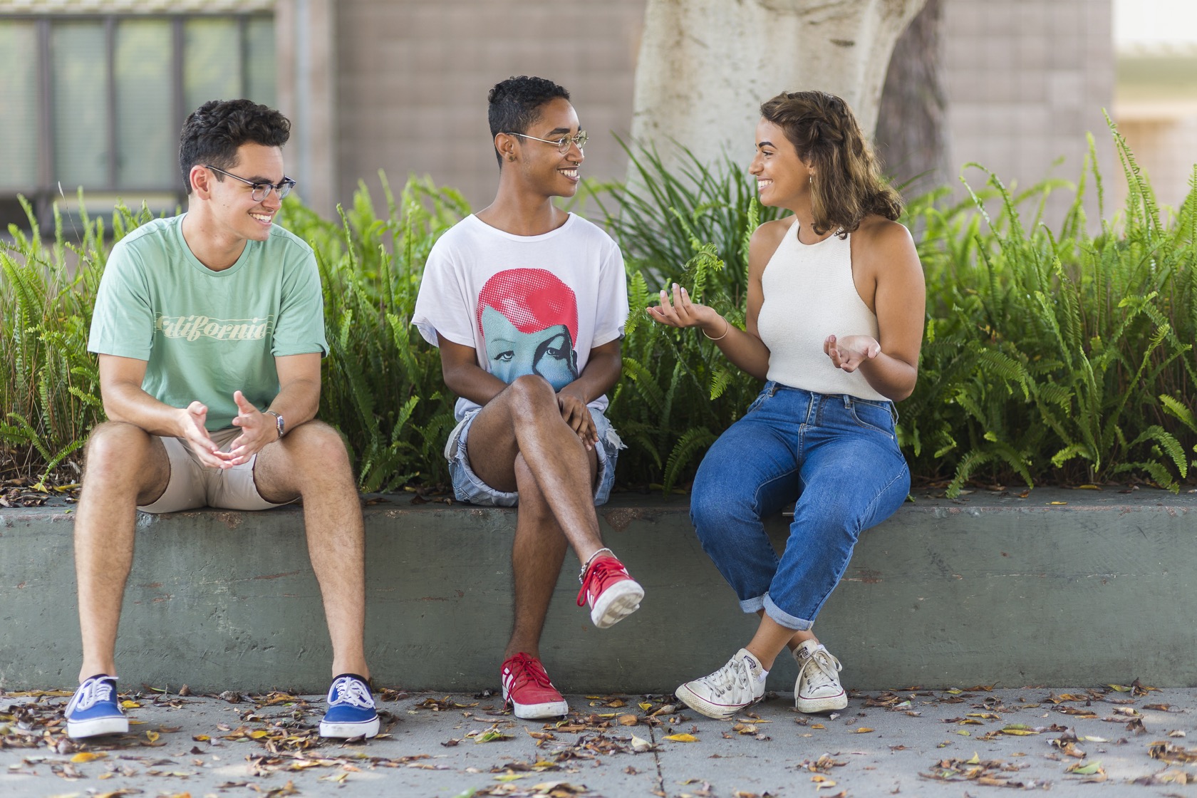 Three students sitting down and talking